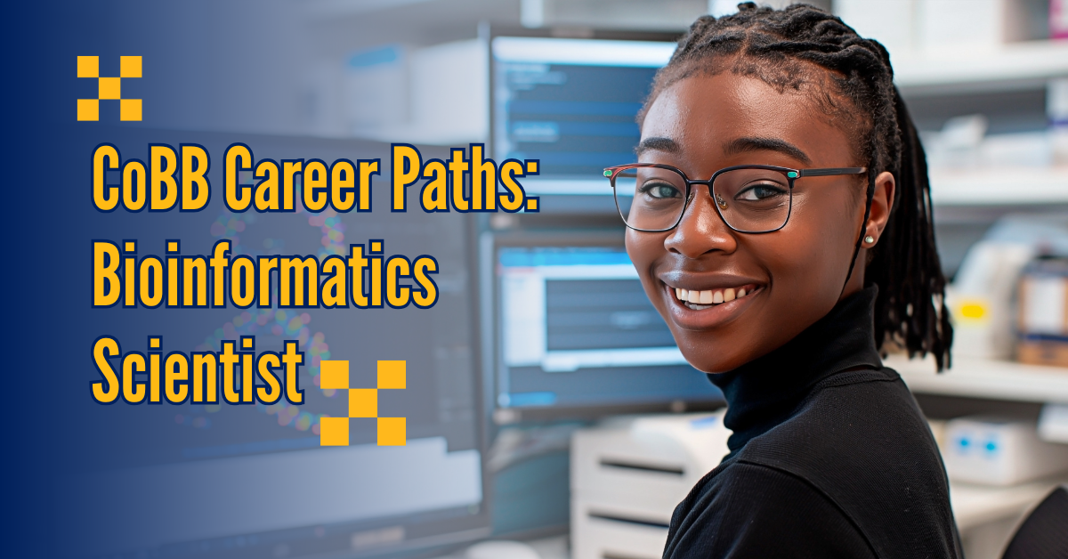 bioinformatics scientist smiling at desk